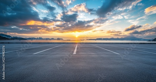 Fototapeta Naklejka Na Ścianę i Meble -  Empty coastal parking lot sunset, cityscape background