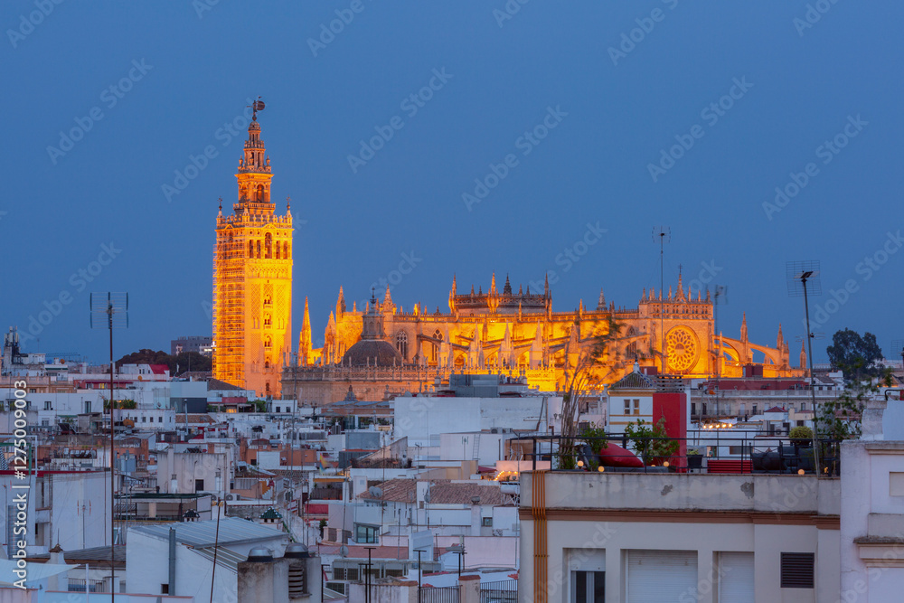 Fototapeta premium Aerial view of Cathedral of Santa Maria de la Sede during blue hour at sunset, Seville, Spain