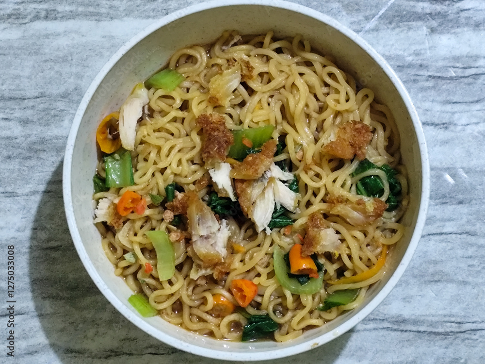 Soy sauce fried noodles served with pickles, chilies, vegetables, etc. Soy sauce fried noodles served with pickles, chilies, vegetables, etc.