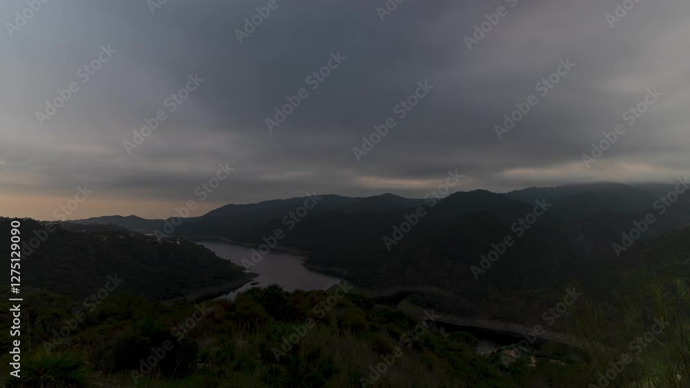 Stormy clouds flow above mountain landscape, time lapse until dark Stormy clouds flow above mountain landscape, time lapse until dark