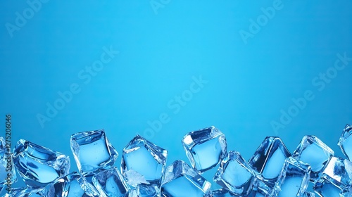 Close-up of many transparent ice cubes against a blue background.