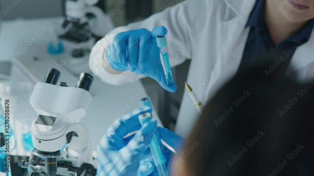 Scientist drop and swing mix aand check chemical a test tube in laboratory for research on pharmacy medical for healing and antibody for protect disease and virus