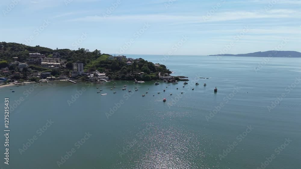 Approaching aerial movement to the coastal island with boats near the Itapema city, Santa Catarina, Brazil. Approaching aerial movement to the coastal island with boats near the Itapema city, Santa Catarina, Brazil.