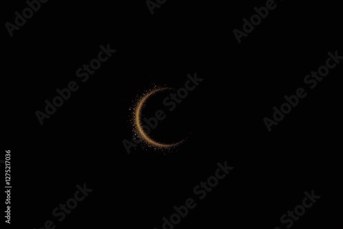 Black background crescent shaped object golden particles starry effect photo