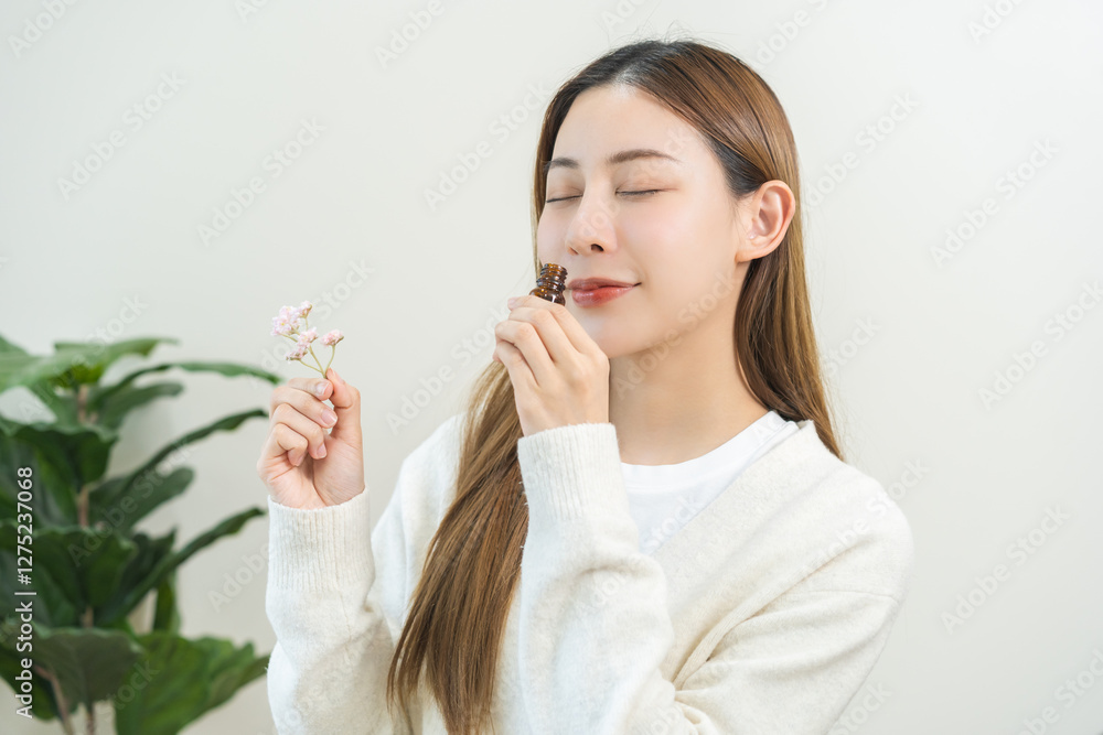Aromatherapy, pretty asian young woman face expression enjoying smell fragrance of herbal from medicine natural organic essential perfume oil.Therapy treatment, beauty skin care isolated on background Aromatherapy, pretty asian young woman face expression enjoying smell fragrance of herbal from medicine natural organic essential perfume oil.Therapy treatment, beauty skin care isolated on background