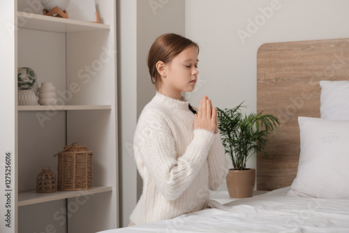 Portrait of praying teenage...