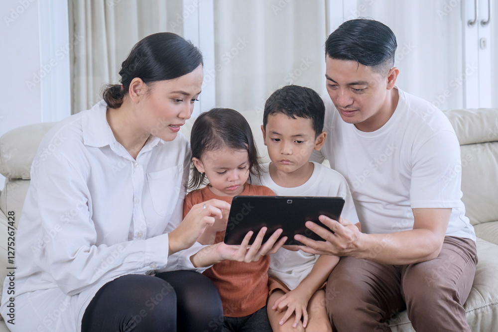 Parents Teaching Their Children Using a Tablet at Home Parents Teaching Their Children Using a Tablet at Home