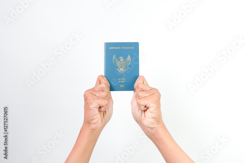 Hand of Indonesian man holding Indonesian Electronic Passport isolated on white background. photo