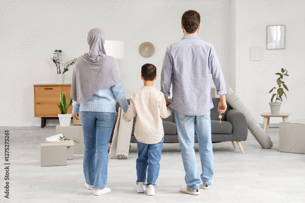 Fototapeta premium Happy Muslim family walking in their new house, back view