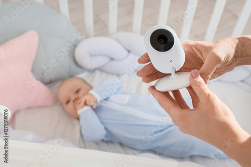 Mother holding baby monitor...