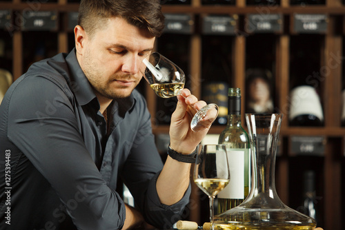 Degustation process of sommelier in wine cellar photo