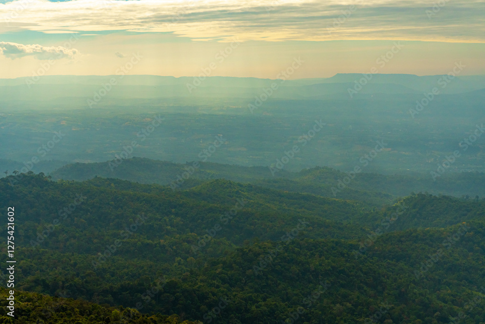 Naklejka premium View of Mountain Tops on a Warm Summer Day – Clouds in the Sky Over the Way to Phu Hin Rong Kla and Phu Lom Lo. Scenic Landscape of Phitsanulok, Thailand. Nature, Travel, and Adventure Destination.