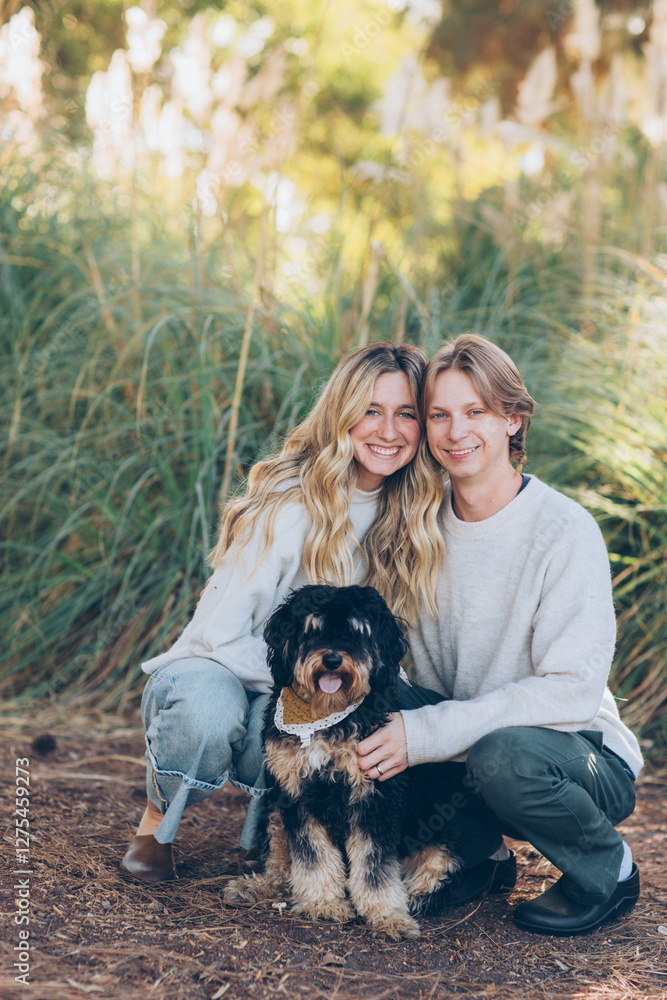 Fototapeta premium Young Couple Posing with their dog