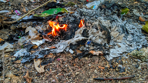 Environmental pollution, Burning garbage and waste outdoors.  Illegal waste disposal, environmental damage, air pollution concept.