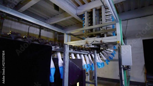 The automated production line in the production workshop of the nitrile glove factory is running for production