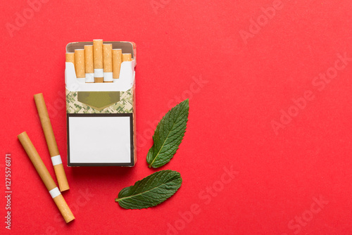 Photos Pack of menthol cigarettes and fresh mint on colored table, Menthol cigarettes t