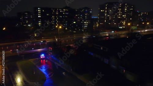 Police and ambulance with emergency lights at night cityscape, aerial view