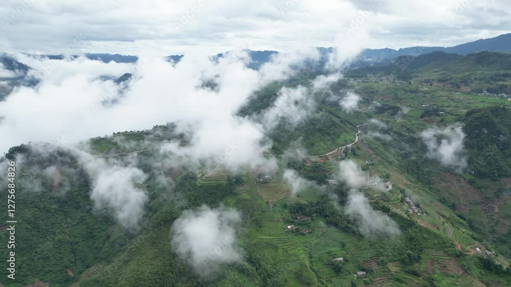 Drone aerial shot of winding mountain road through trees with passing cars and clouds, vietnam. Overcast weather in late summer.
Transfagarasan high mountain road in a cloudy day Drone aerial shot of winding mountain road through trees with passing cars and clouds, vietnam. Overcast weather in late summer.
Transfagarasan high mountain road in a cloudy day