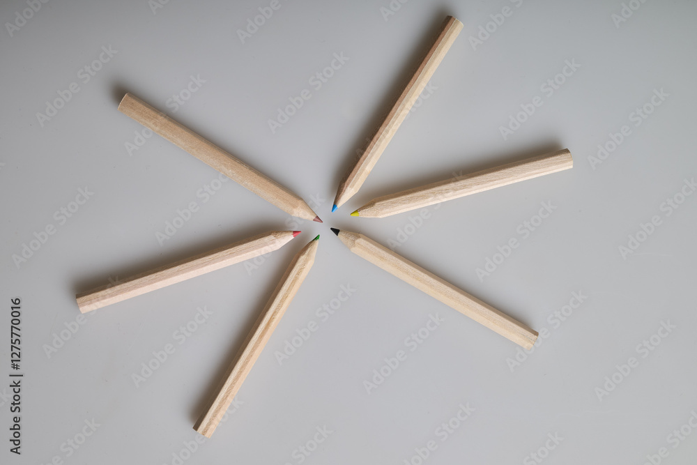 Six raw wooden colored pencils on white background Six raw wooden colored pencils on white background