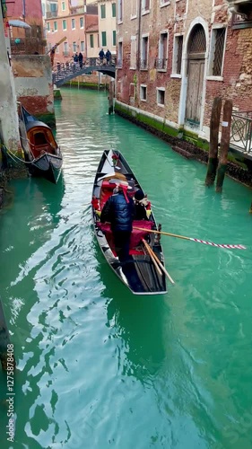 Venetian Canal: A traditional gondola glides gracefully along a serene canal, framed by charming historic buildings and a quaint bridge, capturing the essence of Venetian charm.