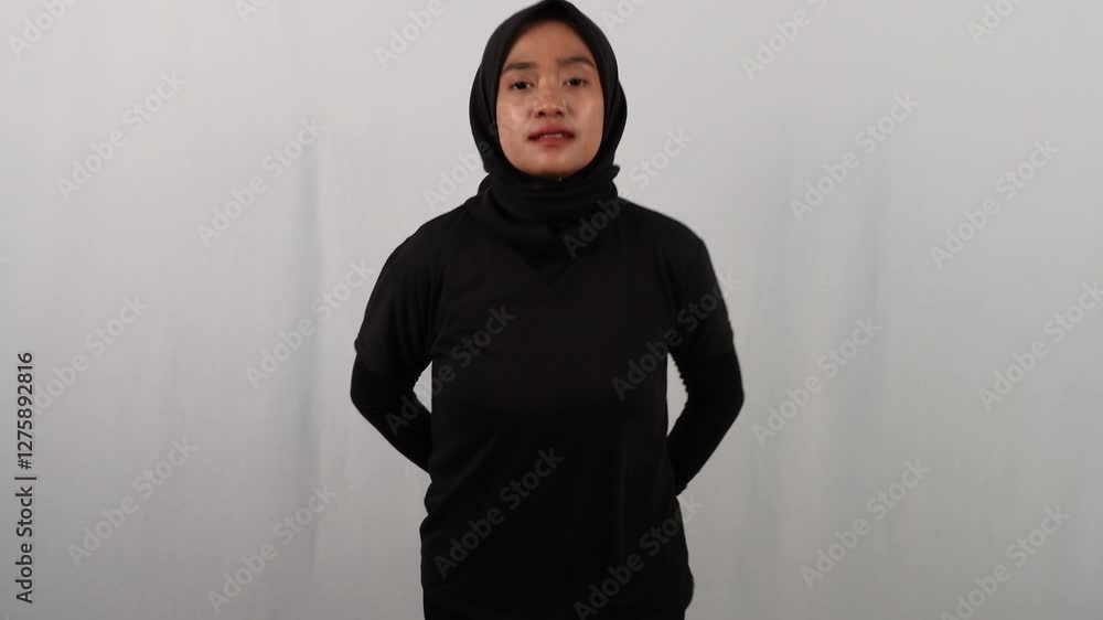 Asian woman wearing hijab exercising indoors Asian woman wearing hijab exercising indoors