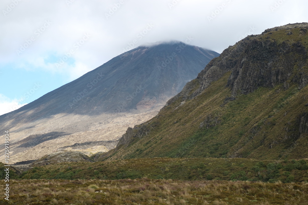A volcanic mountain peak in New Zealand with barren rocky slopes and a deep blue sky. A breathtaking view of geological wonder and adventure. A volcanic mountain peak in New Zealand with barren rocky slopes and a deep blue sky. A breathtaking view of geological wonder and adventure.