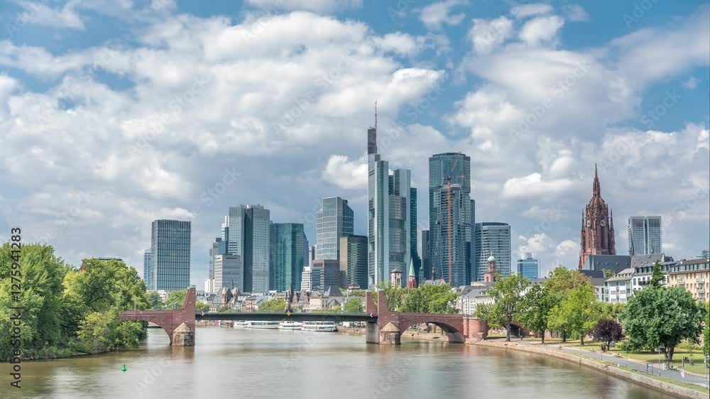 Hyperlapse of Frankfurt's skyscrapers skyline with the bell tower of the Imperial Cathedral of Saint Bartholomew overlooking Alte Brucke, historic stone bridge over the Main River. Frankfurt, Germany Hyperlapse of Frankfurt's skyscrapers skyline with the bell tower of the Imperial Cathedral of Saint Bartholomew overlooking Alte Brucke, historic stone bridge over the Main River. Frankfurt, Germany
