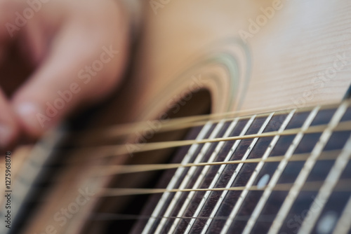Obraz na plátně Close up of strings of a guitar while playing