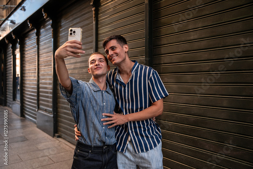 Gay couple capturing memories in vibrant Madrid streets photo