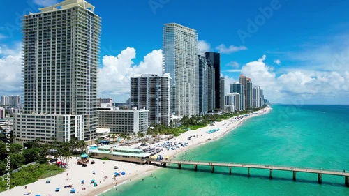 Sunny Isles Beach, Florida - Aerial of Newport Fishing Pier, with luxury condos lining the coastline.