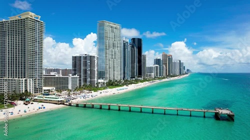 Sunny Isles Beach, Florida - Aerial of Newport Fishing Pier, with luxury condos lining the coastline.