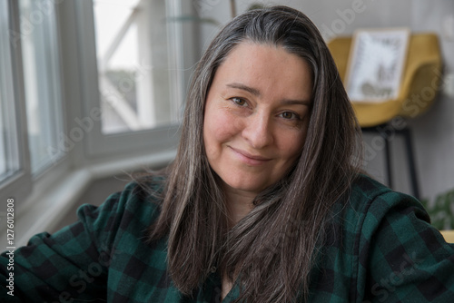 Portrait of a brunette 40+ years old with gray hair