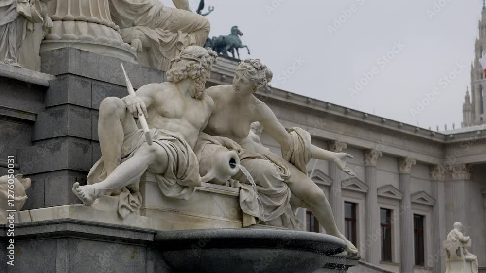 Close-up of the Pallas Athena Fountain in front of the Austrian Parliament in Vienna. The marble statues depict Greek deities with water flowing from a jug. Close-up of the Pallas Athena Fountain in front of the Austrian Parliament in Vienna. The marble statues depict Greek deities with water flowing from a jug.