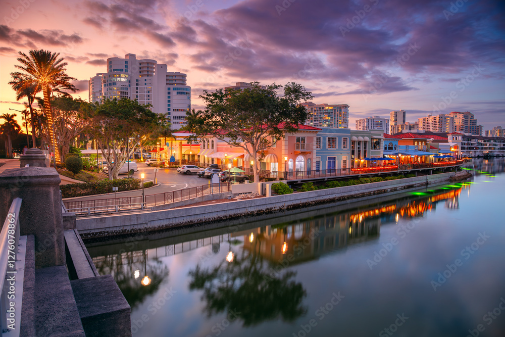 Naples, Florida, USA. Cityscape image of Naples, Florida with reflection of the city skyline in the water at beautiful sunset.