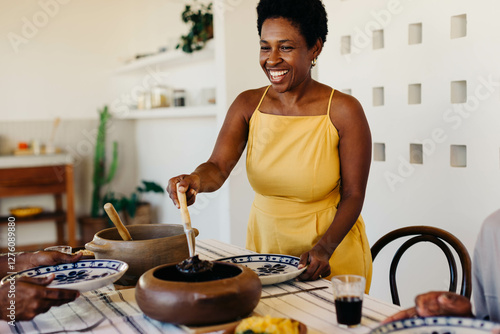 Fotografía Cheerful brazilian family enjoying traditional feijoada meal at home