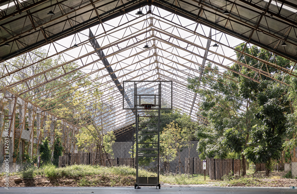 Basketball backboard with the hoop metal ring inside indoor basketball court at city park. use it as your Space for text, Design, Wallpaper and Poster, Selective focus.
