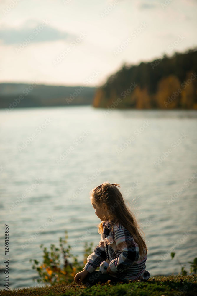 portrait of a five year old girl standing near a lake portrait of a five year old girl standing near a lake