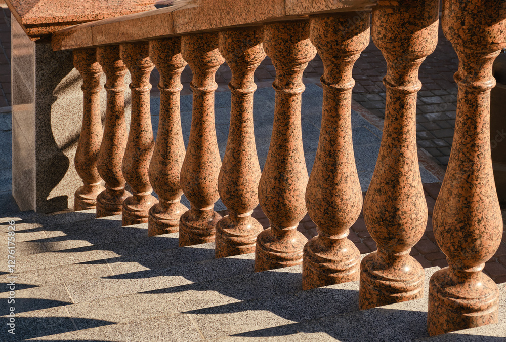 Fototapeta premium Granite balustrade and stairway. Granite ladder with handrail and granite stairs. Selective focus. 