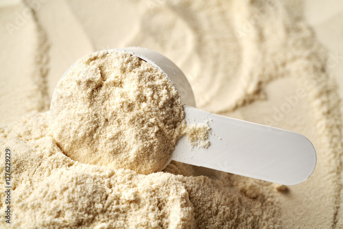 Whey protein powder in a measuring cup