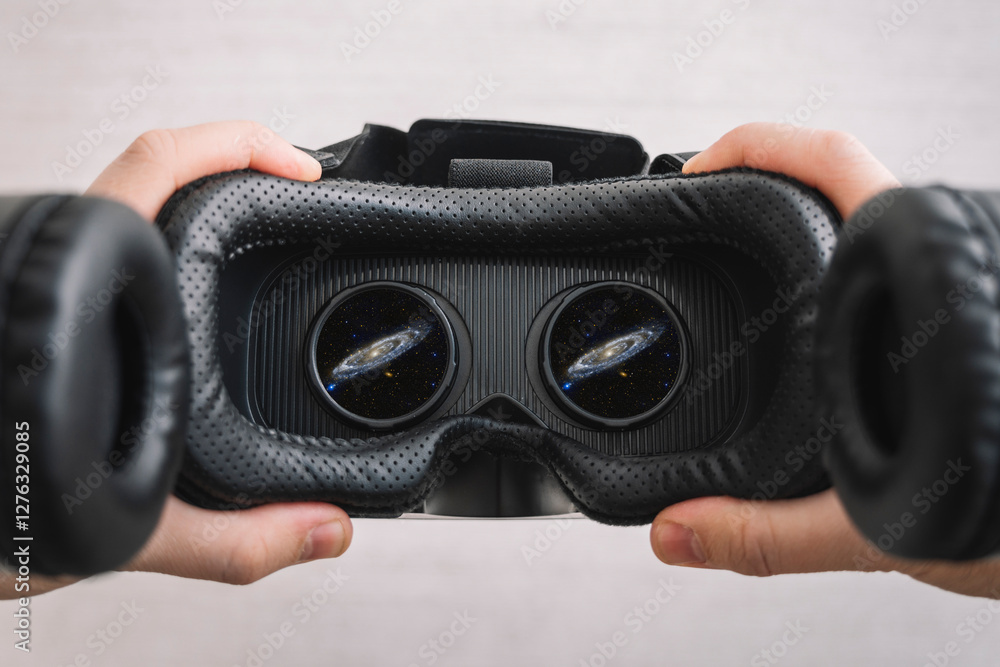a man watching a video in virtual reality glasses. People and technology metaverse concept. 360 degree video viewing. outer space with vr glasses. Used a photo from the NASA collection