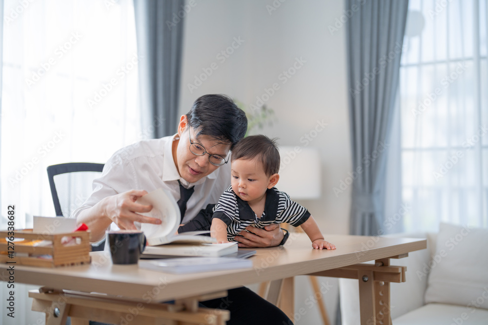 Father engaged in a learning activity with his baby at home during the day Father engaged in a learning activity with his baby at home during the day