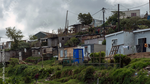 South Africa informal settlement on a hill, houses made of corrugated metal sheet and cardboard photo