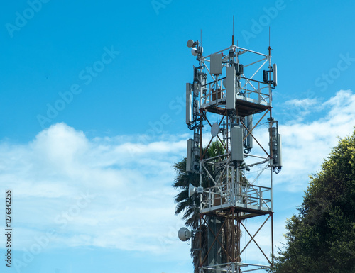 Telecom tower, cellular communication for 4g and 5g networks, wireless services. Blue sky