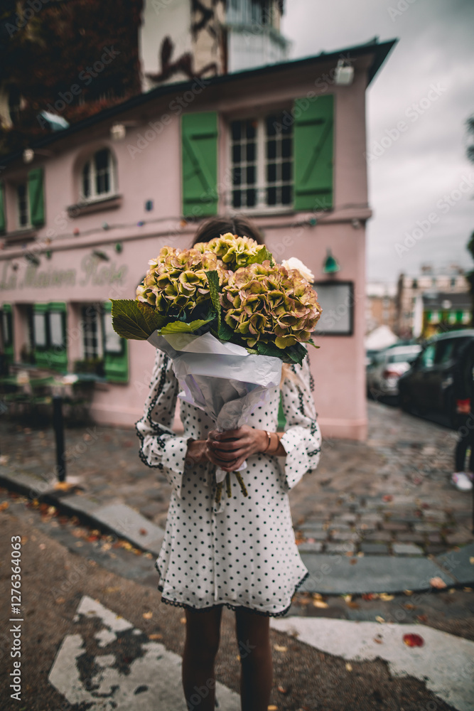 Fototapeta premium Woman holding a bouquet of peonies in Paris