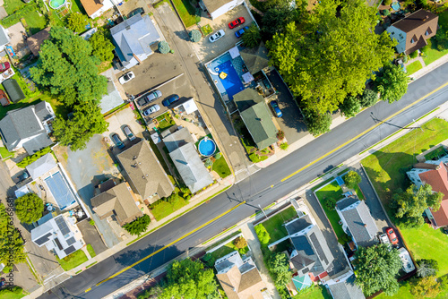 View captures sunny suburban neighborhood with houses, pool, green spaces at Sayreville American town New Jersey photo