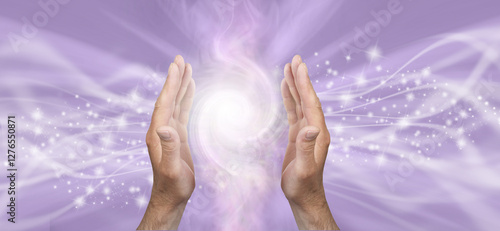 Light worker sensing double Fibonacci high vibration healing energy field  - male parallel hands against a lilace bacgkround and copy space for spiritual message
