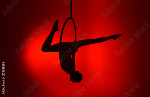 Aerial gymnastics. Gymnast on aerial hoop. Athlete trains on aerial hoop
