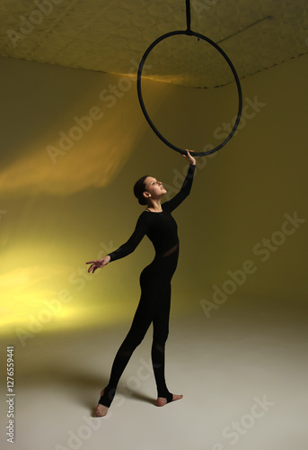 Aerial gymnastics. Gymnast on aerial hoop. Athlete trains on aerial hoop