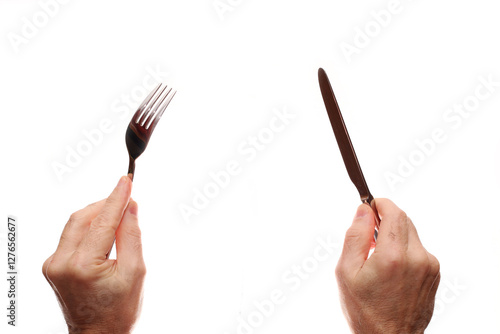 Knife and fork in hands on a white background.
