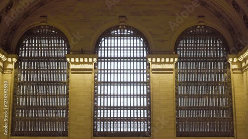 Rays of Light Through Grand Central's Arches with people passing in New York